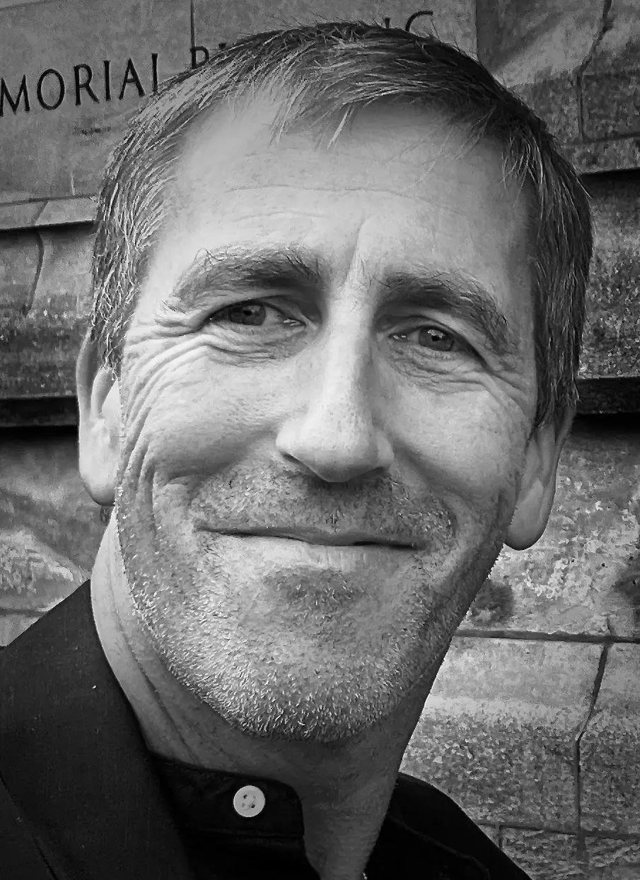 Black and white headshot of Christopher Carter, Global CEO of ExpatInsure expert in financial services and digital health insurance innovation, previously Head of Marketing and Chief Digital Officer at Cigna Global Health.