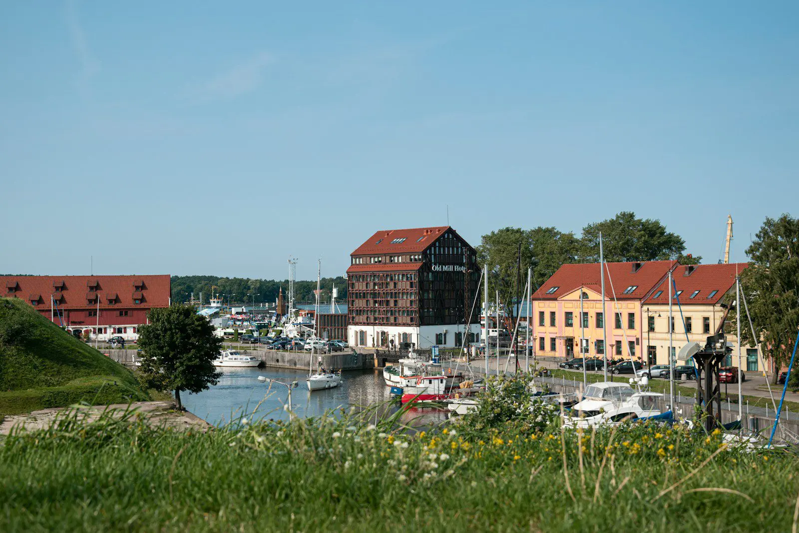 Scenic view of Klaipėda Old Town marina with colorful buildings and boats, symbolizing expat life and relocation to Lithuania.