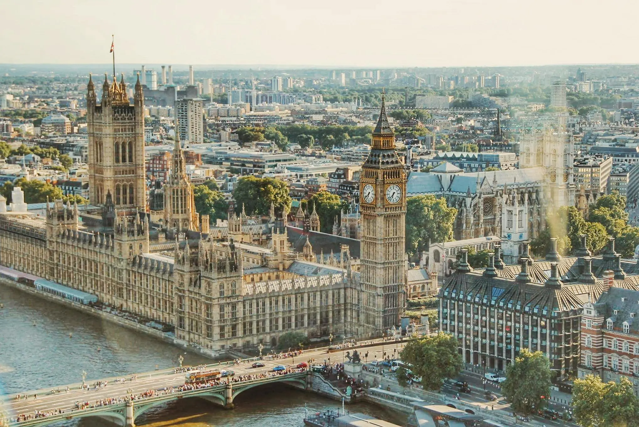 Aerial view of Big Ben and the Houses of Parliament in London overlooking the River Thames, representing the UK’s iconic architecture and culture.