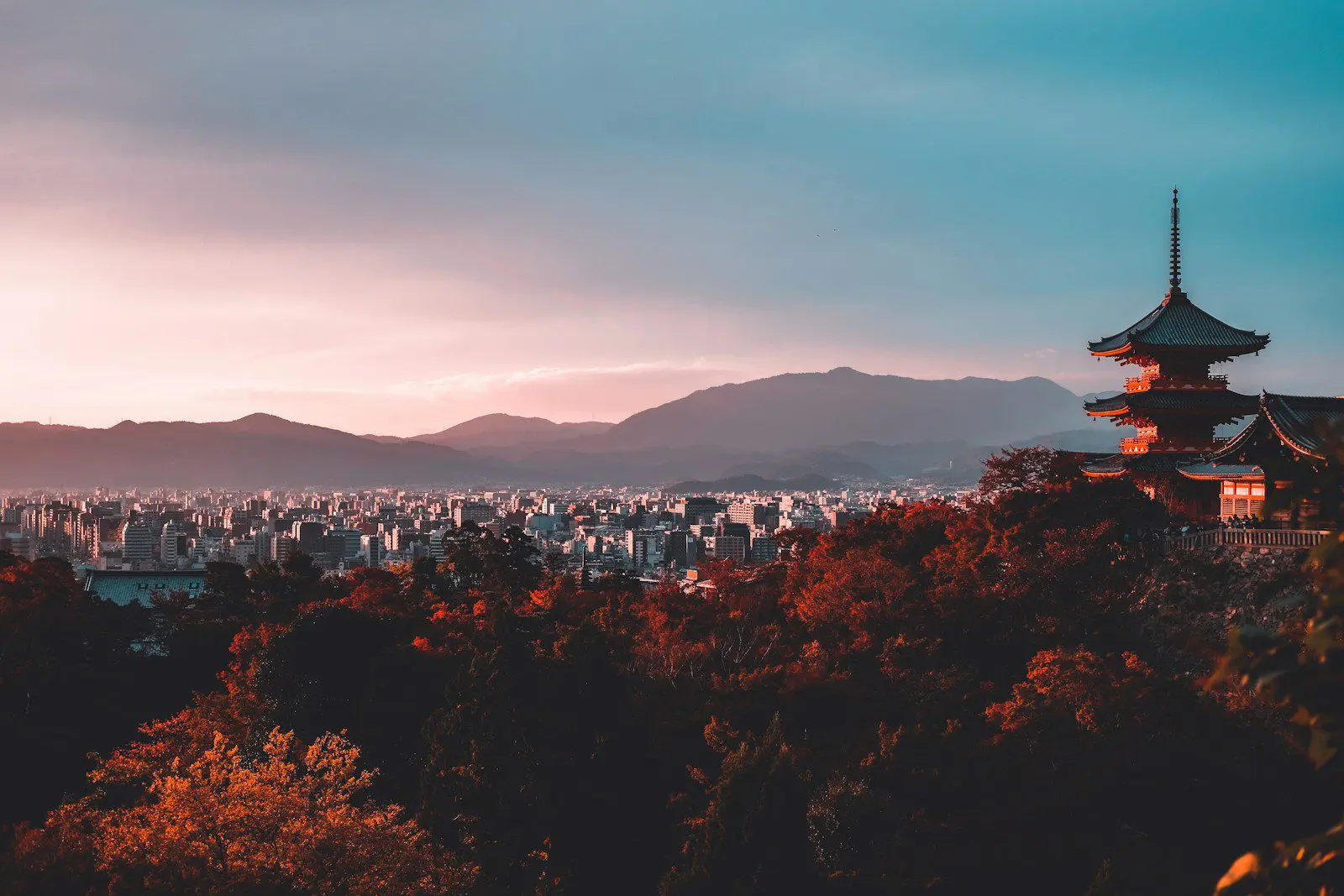 Scenic view of a Japanese pagoda overlooking Kyoto city at sunset, representing Japan’s mix of tradition and modern life for expats.