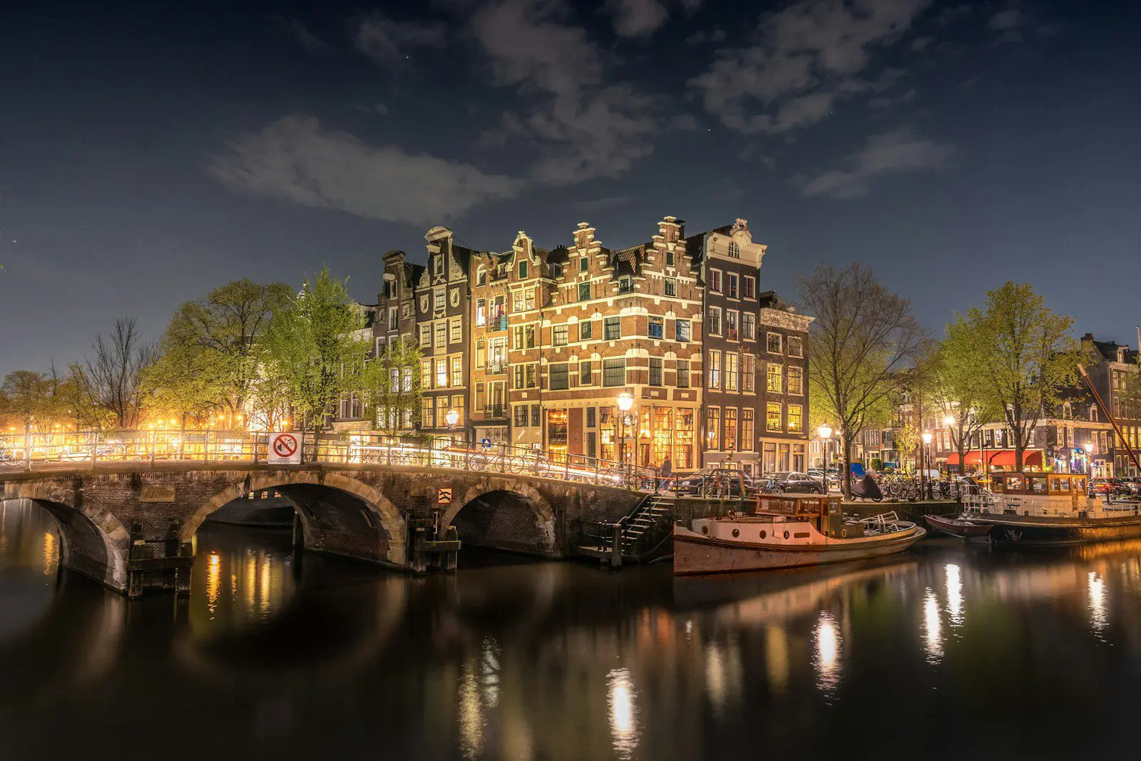 Amsterdam canal houses at night symbolizing life in the Netherlands for expats applying for Dutch visas and residence permits.