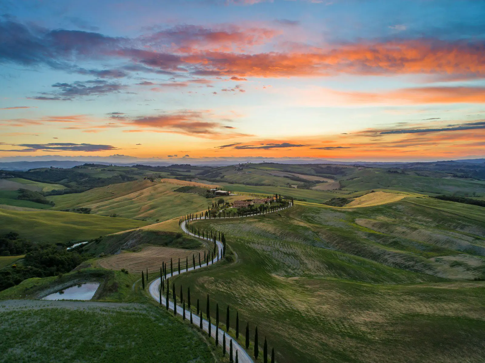Tuscany countryside road at sunset, showcasing Italy’s scenic landscapes and expat travel charm.
