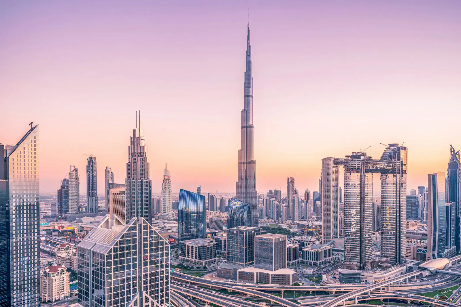 Dubai skyline at sunset featuring Burj Khalifa and modern architecture, showcasing expat city living and investment opportunities.