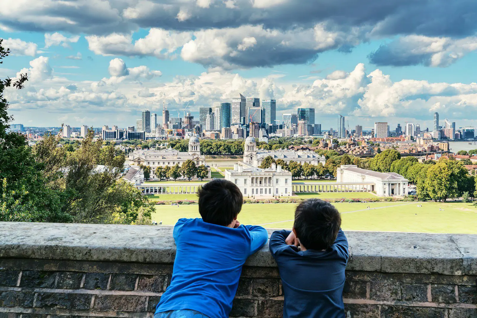 Two children overlooking London skyline, symbolizing expat families planning their move to the UK and navigating visa applications.