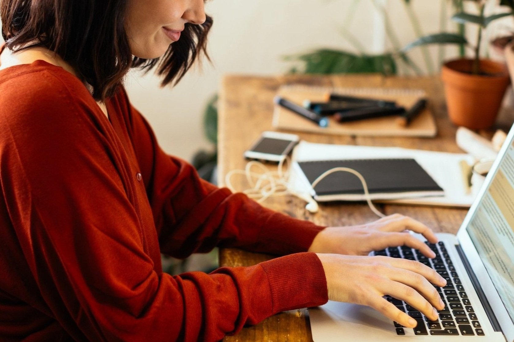 Side View Of A Woman Typing On Laptop