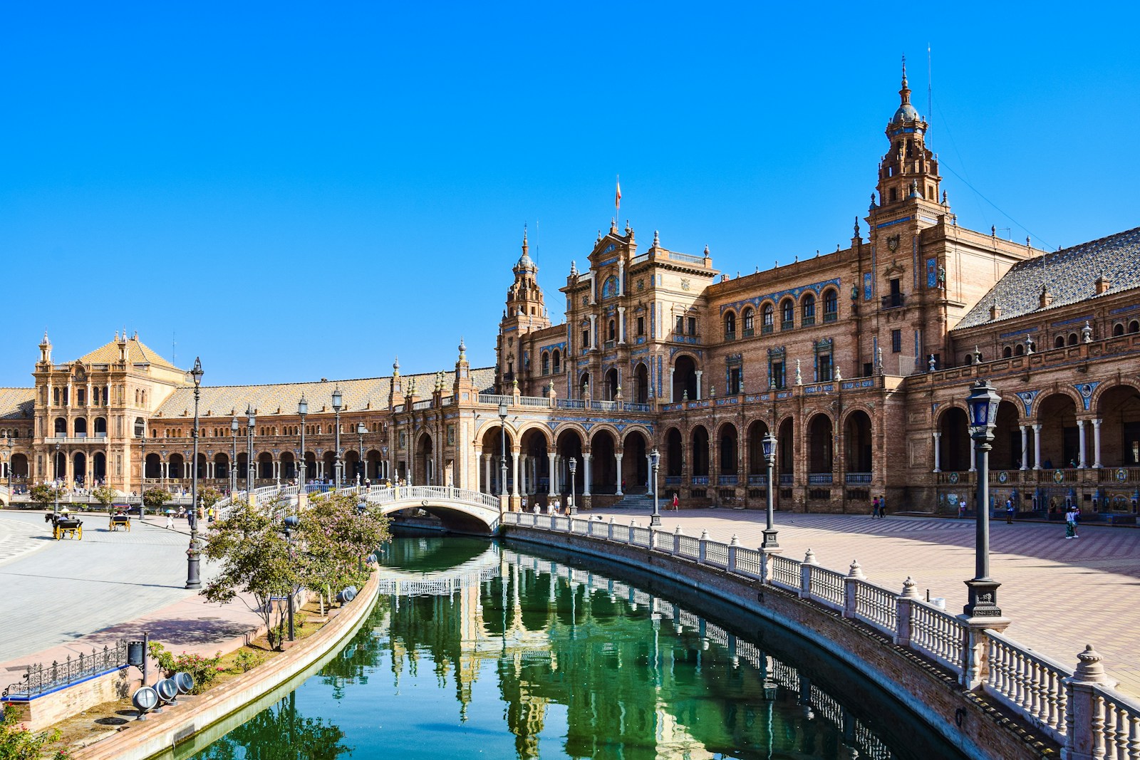 Photo by AXP Photography a large building with a pool in front of it