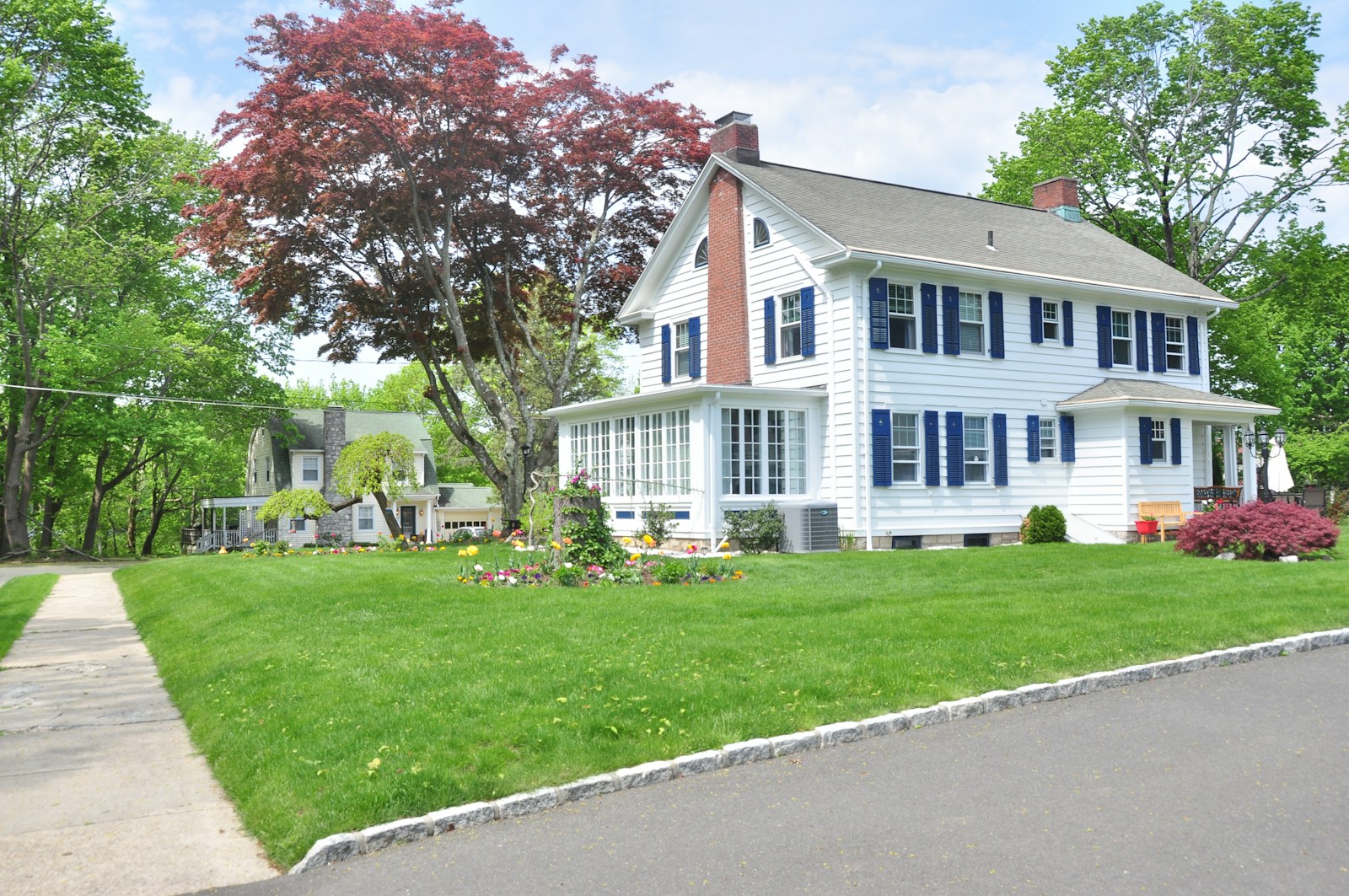 Photo by I Do Nothing But Love white and gray house near green grass field and trees during daytime