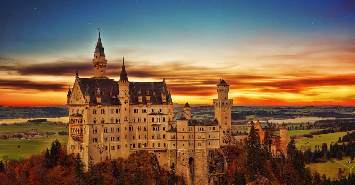 pexels-photo-1119972-1119972 Breathtaking view of Neuschwanstein Castle in Germany during a vibrant sunset scene.