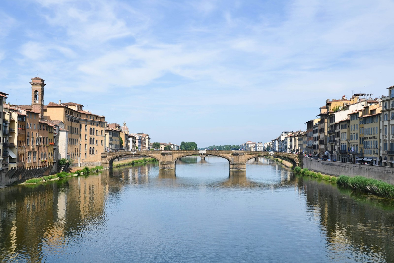 Photo by Jocelyn Hsu river between concrete buildings under blue sky during daytime