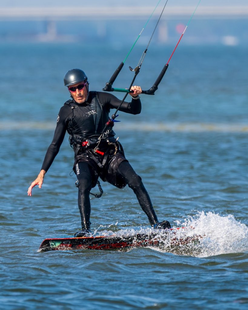 A man on a surfboard holding onto a handle