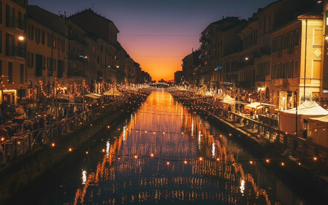 reflective photography of string lights above river